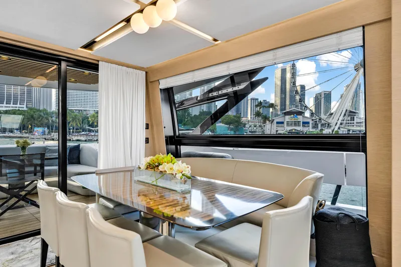 Slide: The Image of Luxurious interior of 2021 Azimut S10 yacht with elegant dining area and cityscape view. - 23