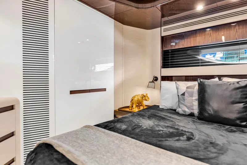 Slide: The Image of Luxurious Azimut S10 2021 yacht bedroom with elegant decor and plush bedding. - 42