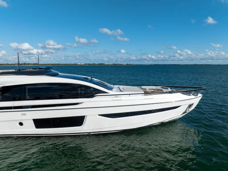 Slide: The Image of 2021 Azimut S10 yacht cruising on open water under a clear blue sky. - 6