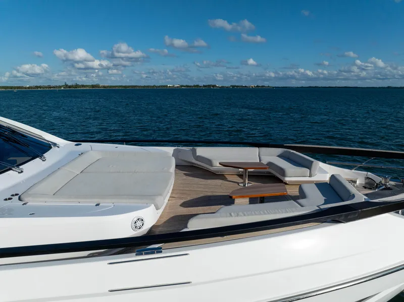 Slide: The Image of Azimut S10 2021 yacht with luxurious deck seating, overlooking serene ocean waters. - 8
