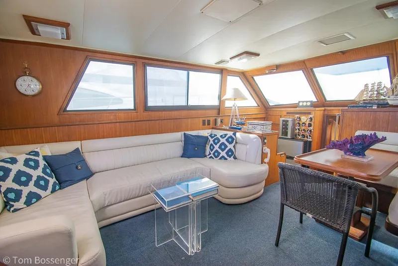 Slide: The Image of Interior of 1986 Hatteras 43 Motor Yacht with plush seating and elegant decor. - 10