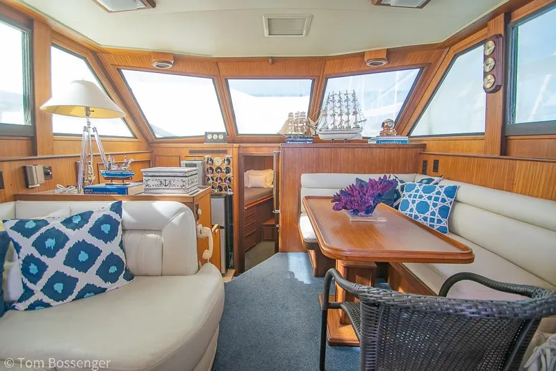 Slide: The Image of Interior of 1986 Hatteras 43 Motor Yacht with elegant seating and nautical decor. - 14