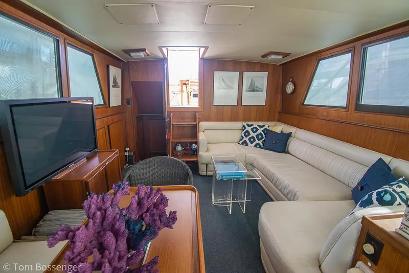 Slide: The Image of Interior of 1986 Hatteras 43 Motor Yacht with cozy seating and nautical decor. - 16