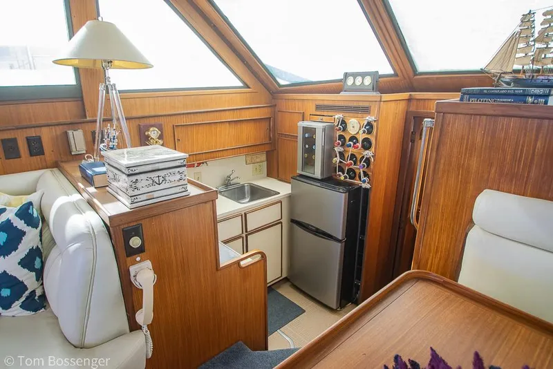 Slide: The Image of Interior of 1986 Hatteras 43 Motor Yacht with kitchenette and wooden cabinetry. - 17