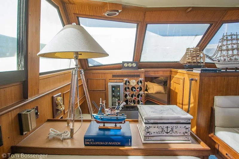 Slide: The Image of Interior of 1986 Hatteras 43 Motor Yacht with nautical decor and wooden furnishings. - 18