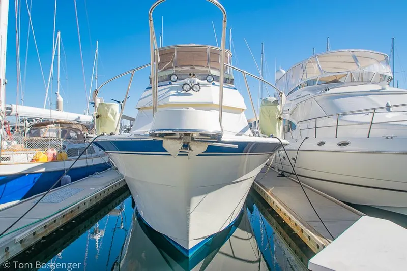 Slide: The Image of 1986 Hatteras 43 Motor Yacht docked at marina, front view, clear blue sky. - 3