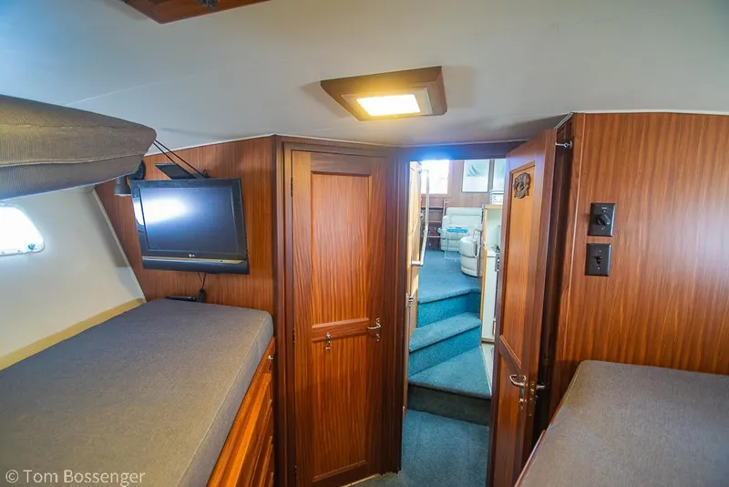 Slide: The Image of Interior of 1986 Hatteras 43 Motor Yacht with wood paneling and cozy cabin. - 32