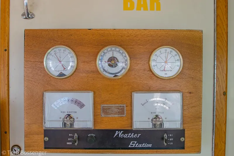 Slide: The Image of Weather station panel on 1986 Hatteras 43 Motor Yacht, featuring gauges and dials. - 38