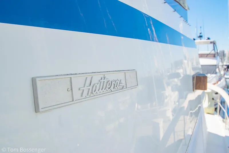 Slide: The Image of 1986 Hatteras 43 Motor Yacht with blue stripe and logo detail. - 4