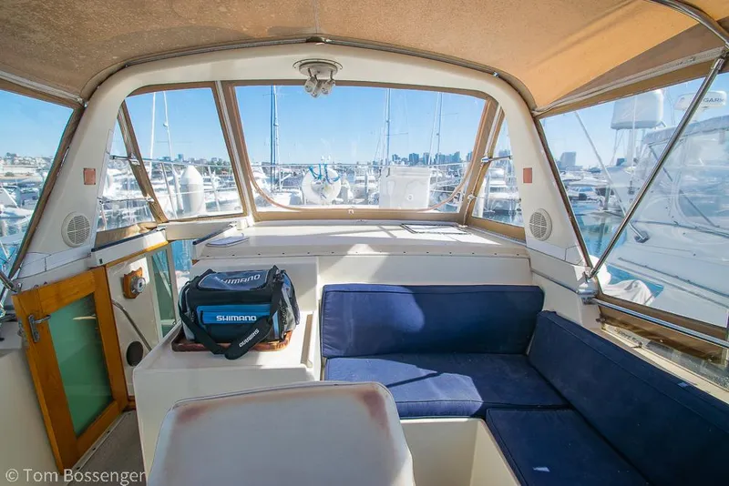 Slide: The Image of 1986 Hatteras 43 Motor Yacht interior with blue seating and marina view. - 41