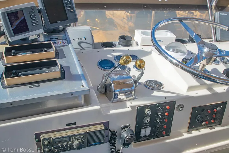 Slide: The Image of Control panel of a 1986 Hatteras 43 Motor Yacht with steering wheel and navigation equipment. - 45