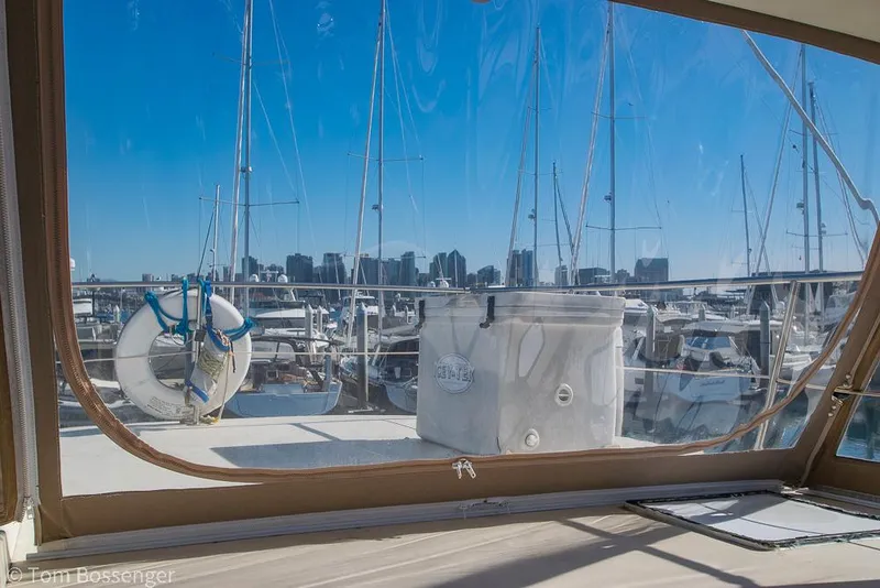 Slide: The Image of 1986 Hatteras 43 Motor Yacht docked, view from cabin with marina and city skyline. - 47