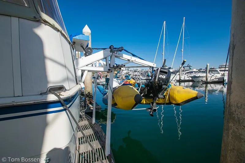 Slide: The Image of 1986 Hatteras 43 Motor Yacht docked with yellow inflatable boat and outboard motor. - 48