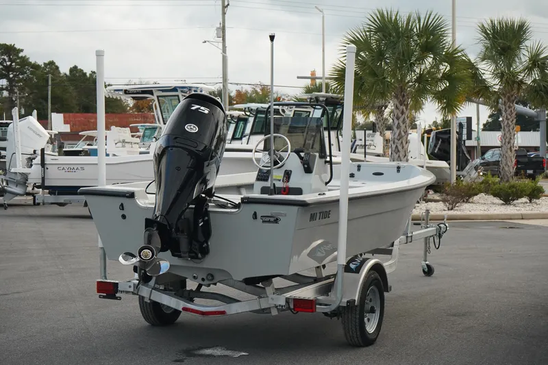 Slide: The Image of 2025 Mi Tide V1602 boat on trailer with outboard motor in parking lot. - 4