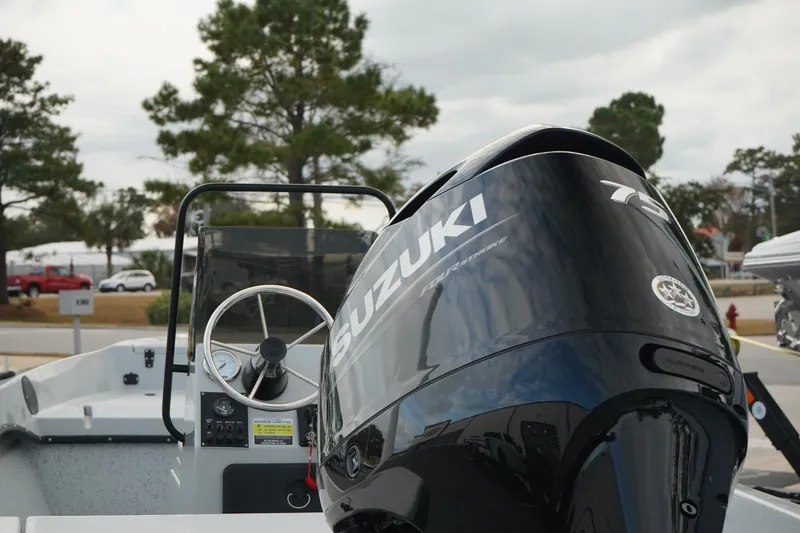 Slide: The Image of Mi Tide V1602 boat with Suzuki outboard motor, 2025 model, parked outdoors. - 5