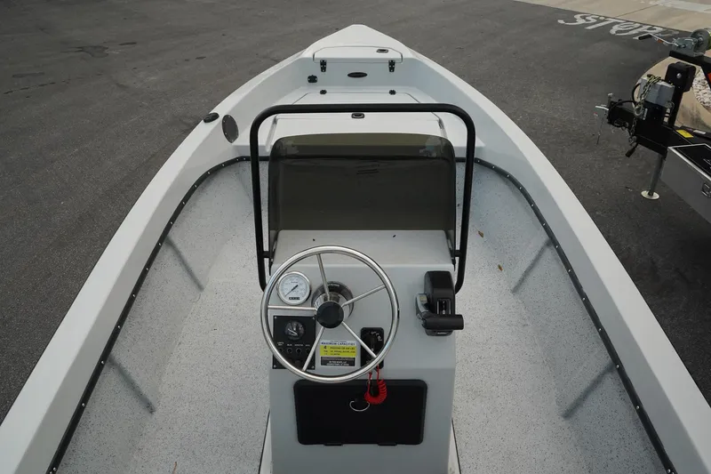 Slide: The Image of Mi Tide V1602 boat interior, 2025 model, featuring steering console and spacious deck. - 9