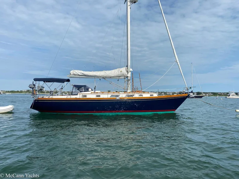 Slide: The Image of 1988 Bristol 41.1 Aft Cockpit sailboat on calm water under a cloudy sky. - 10