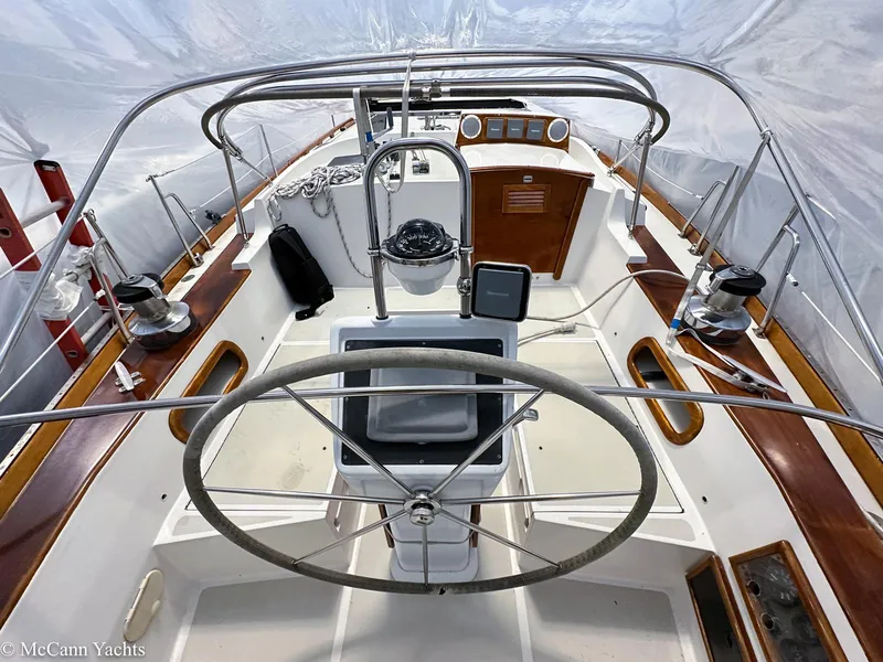 Slide: The Image of 1988 Bristol 41.1 Aft Cockpit sailboat interior with steering wheel and navigation equipment. - 12