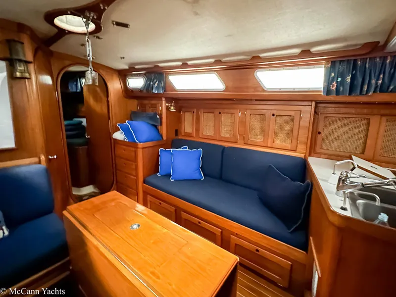 Slide: The Image of 1988 Bristol 41.1 Aft Cockpit interior with wooden finish and blue cushions. - 15