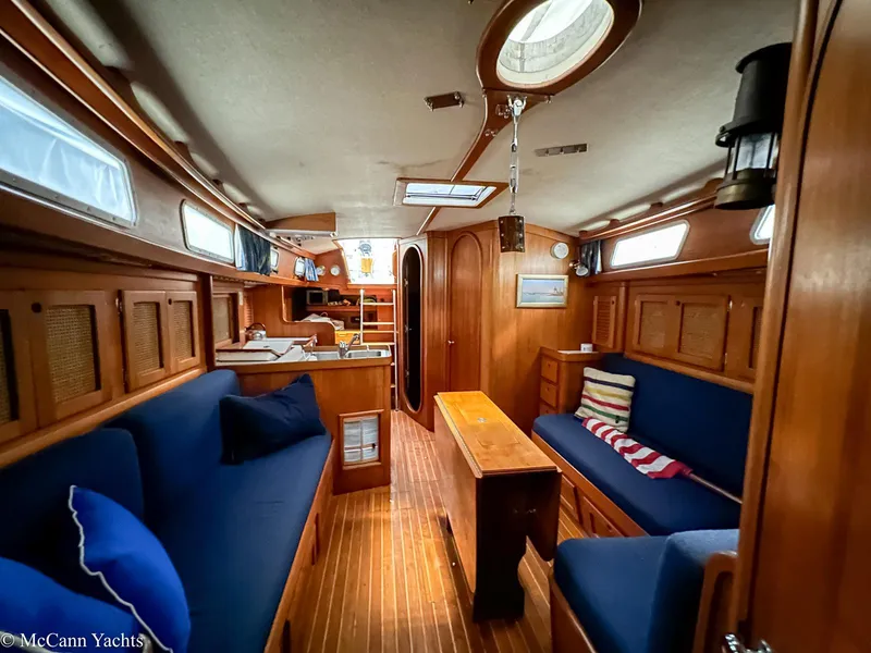 Slide: The Image of Interior of 1988 Bristol 41.1 Aft Cockpit yacht with wooden furnishings and blue seating. - 16