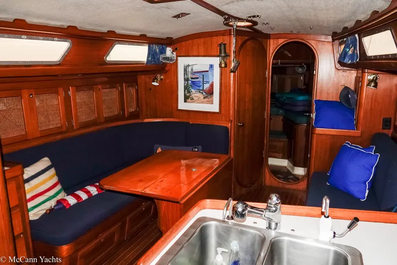 Slide: The Image of 1988 Bristol 41.1 Aft Cockpit interior with wooden finish, blue seating, and kitchen sink. - 17