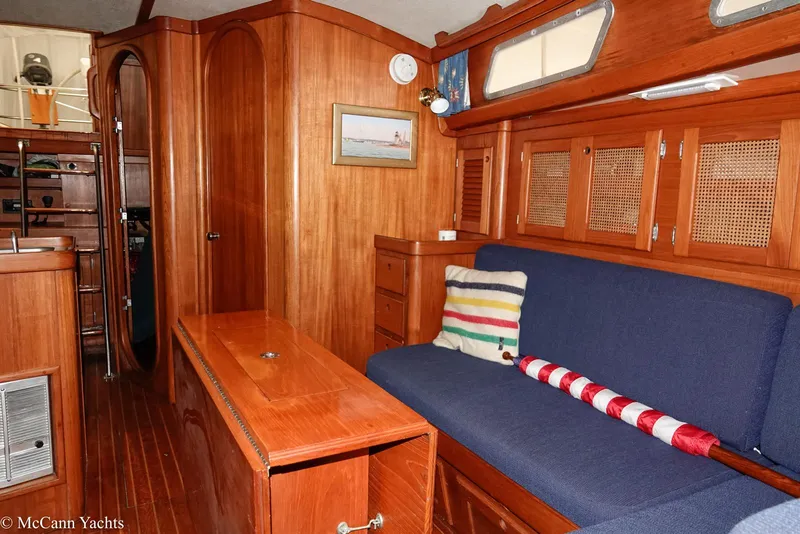Slide: The Image of Interior of 1988 Bristol 41.1 Aft Cockpit yacht with wooden furnishings and blue seating. - 26