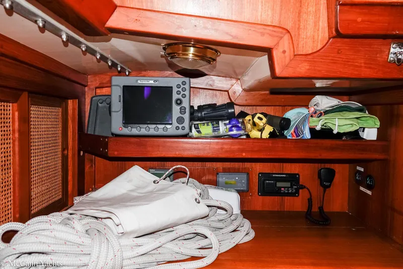 Slide: The Image of 1988 Bristol 41.1 Aft Cockpit interior with navigation equipment and storage shelves. - 34