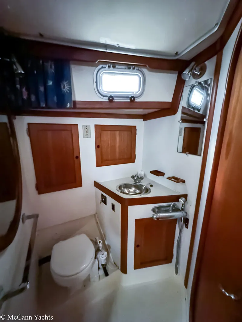 Slide: The Image of 1988 Bristol 41.1 Aft Cockpit yacht bathroom with wooden cabinets and stainless steel sink. - 35
