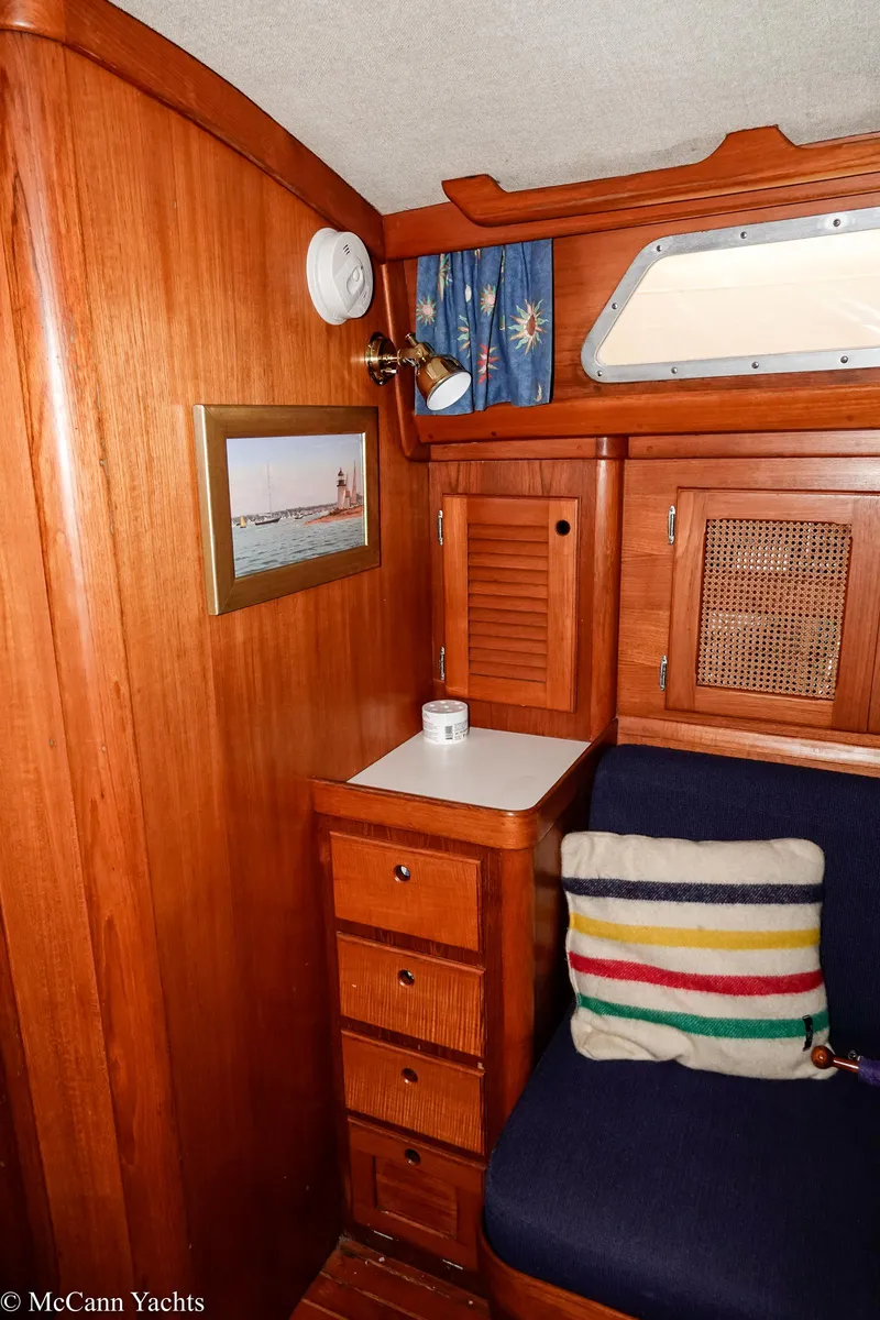 Slide: The Image of Interior of 1988 Bristol 41.1 Aft Cockpit yacht with wooden cabinetry and colorful cushion. - 39