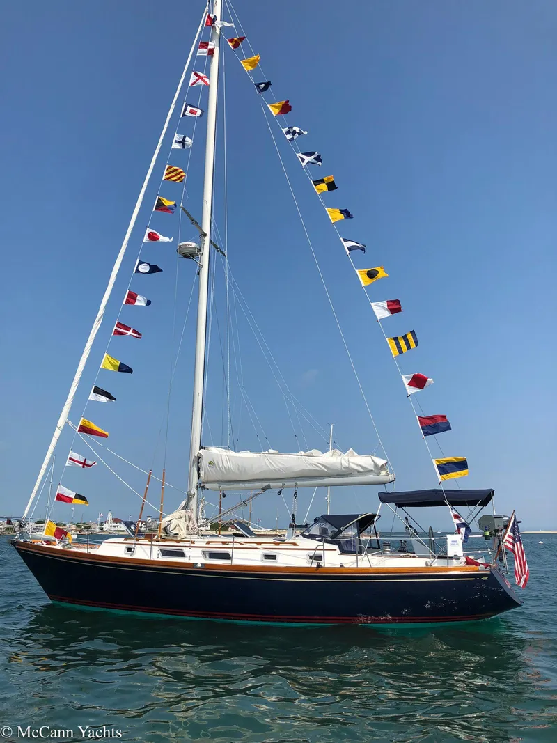 Slide: The Image of 1988 Bristol 41.1 Aft Cockpit sailboat with colorful flags on a sunny day. - 4