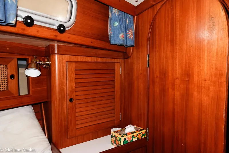 Slide: The Image of 1988 Bristol 41.1 Aft Cockpit interior with wooden cabinetry and nautical decor. - 44
