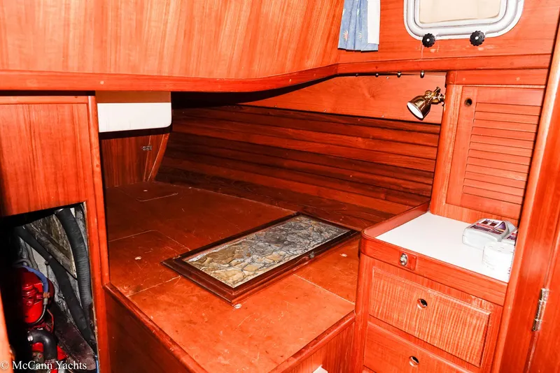 Slide: The Image of 1988 Bristol 41.1 Aft Cockpit interior with wooden cabinetry and cozy sleeping area. - 45