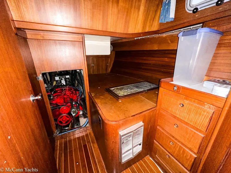 Slide: The Image of 1988 Bristol 41.1 Aft Cockpit interior with wooden cabinetry and visible engine compartment. - 46