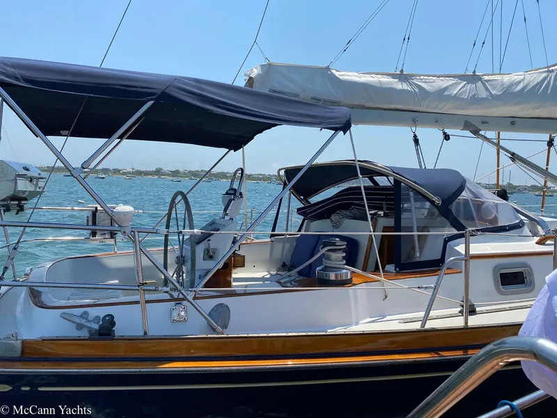 Slide: The Image of 1988 Bristol 41.1 Aft Cockpit yacht with blue canopy, docked on a sunny day. - 5
