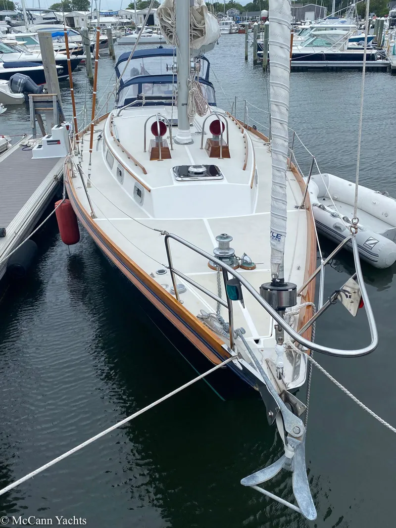 Slide: The Image of 1988 Bristol 41.1 Aft Cockpit sailboat docked in marina, featuring classic design and spacious deck. - 8