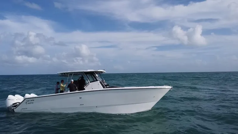 Slide: The Image of 2024 Sedna 370 Open boat cruising on the ocean under a partly cloudy sky. - 12