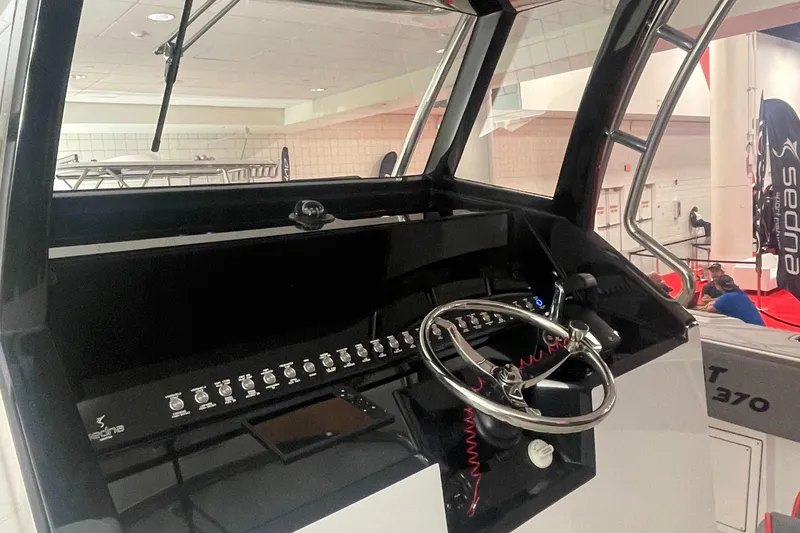 Slide: The Image of Sedna 370 Open 2024 boat dashboard with steering wheel and control panel. - 5