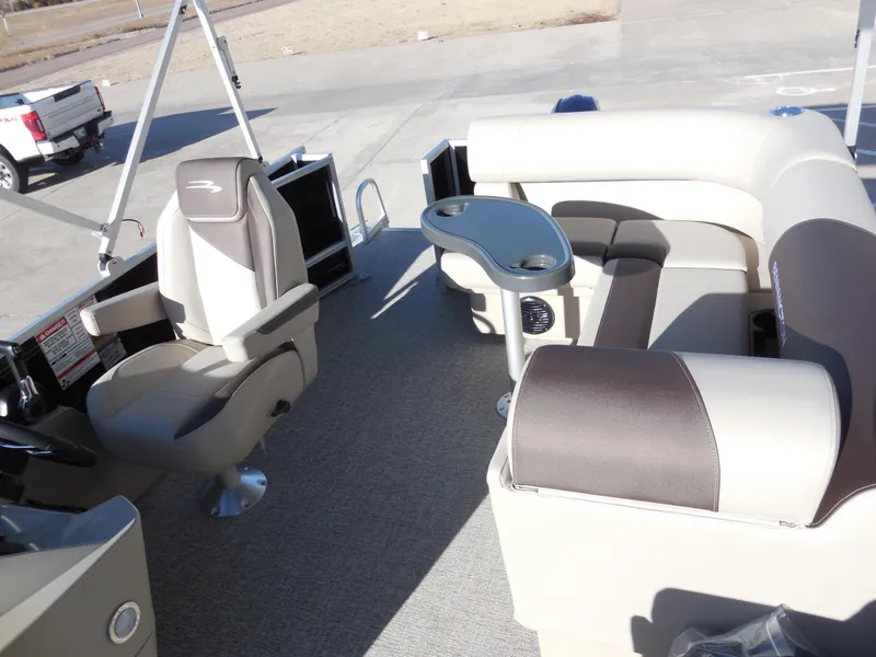 Slide: The Image of 2025 Bennington 188 SL pontoon boat interior with plush seating and captain's chair. - 6