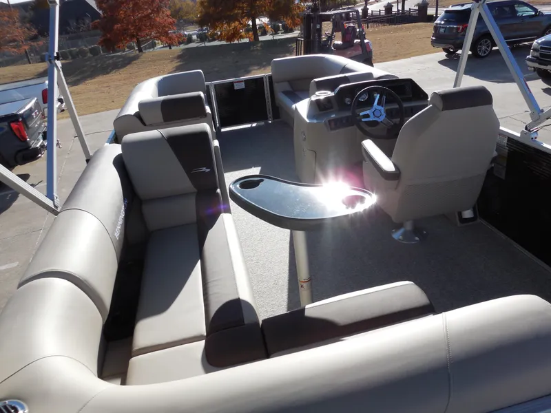 Slide: The Image of 2025 Bennington 188 SL pontoon boat interior with plush seating and steering console. - 8