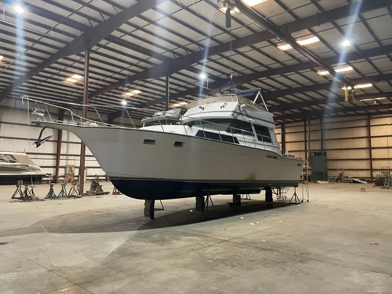 Slide: The Image of 1989 Marinette 41 Marquis Convertible yacht in spacious indoor storage facility. - 1