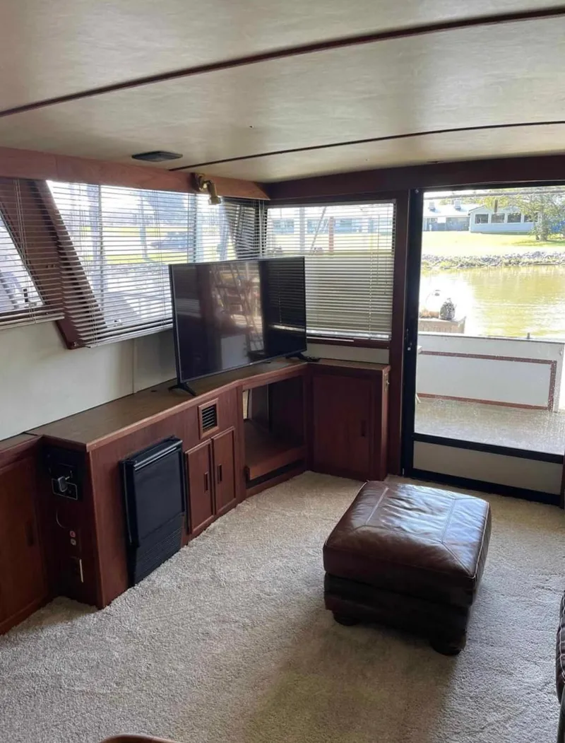 Slide: The Image of Interior of 1989 Marinette 41 Marquis Convertible yacht with TV and leather ottoman. - 11