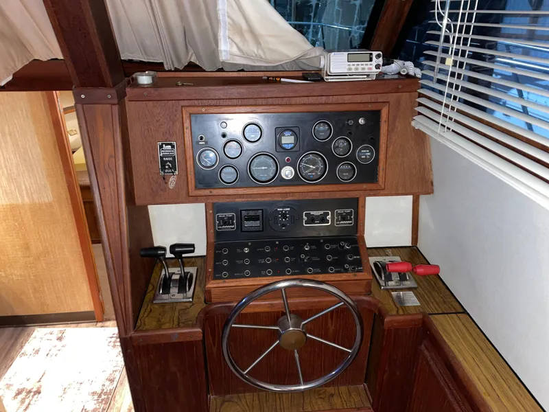 Slide: The Image of 1989 Marinette 41 Marquis Convertible helm with gauges, controls, and steering wheel. - 13