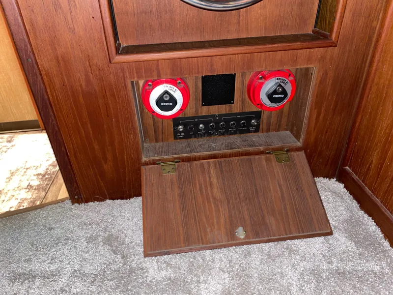Slide: The Image of 1989 Marinette 41 Marquis Convertible control panel with red switches and wooden finish. - 14