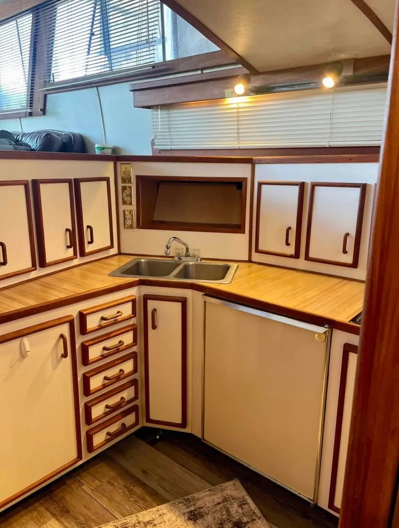 Slide: The Image of 1989 Marinette 41 Marquis Convertible kitchen with wood cabinets and countertop. - 19