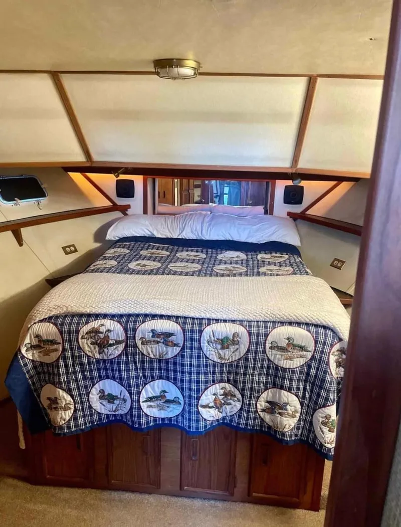 Slide: The Image of Cozy bedroom in 1989 Marinette 41 Marquis Convertible boat with nautical-themed bedding. - 20