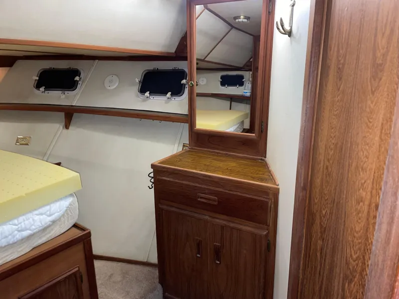 Slide: The Image of 1989 Marinette 41 Marquis Convertible cabin interior with wood cabinetry and mirror. - 21