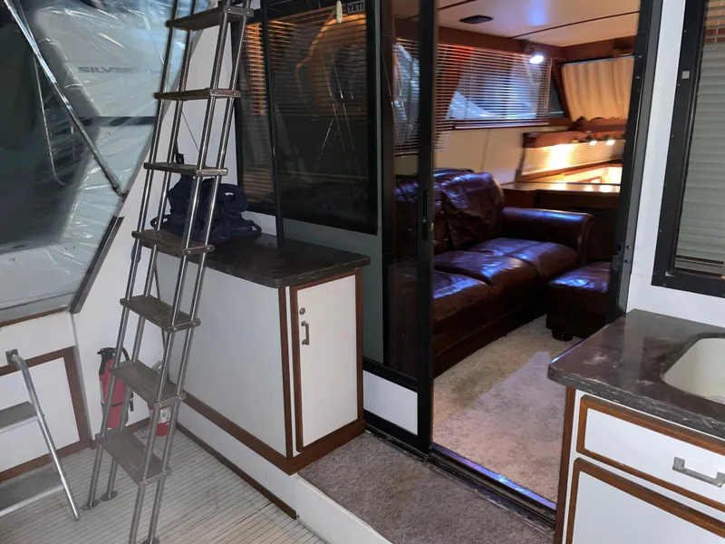 Slide: The Image of Interior of 1989 Marinette 41 Marquis Convertible yacht with leather seating and modern amenities. - 25
