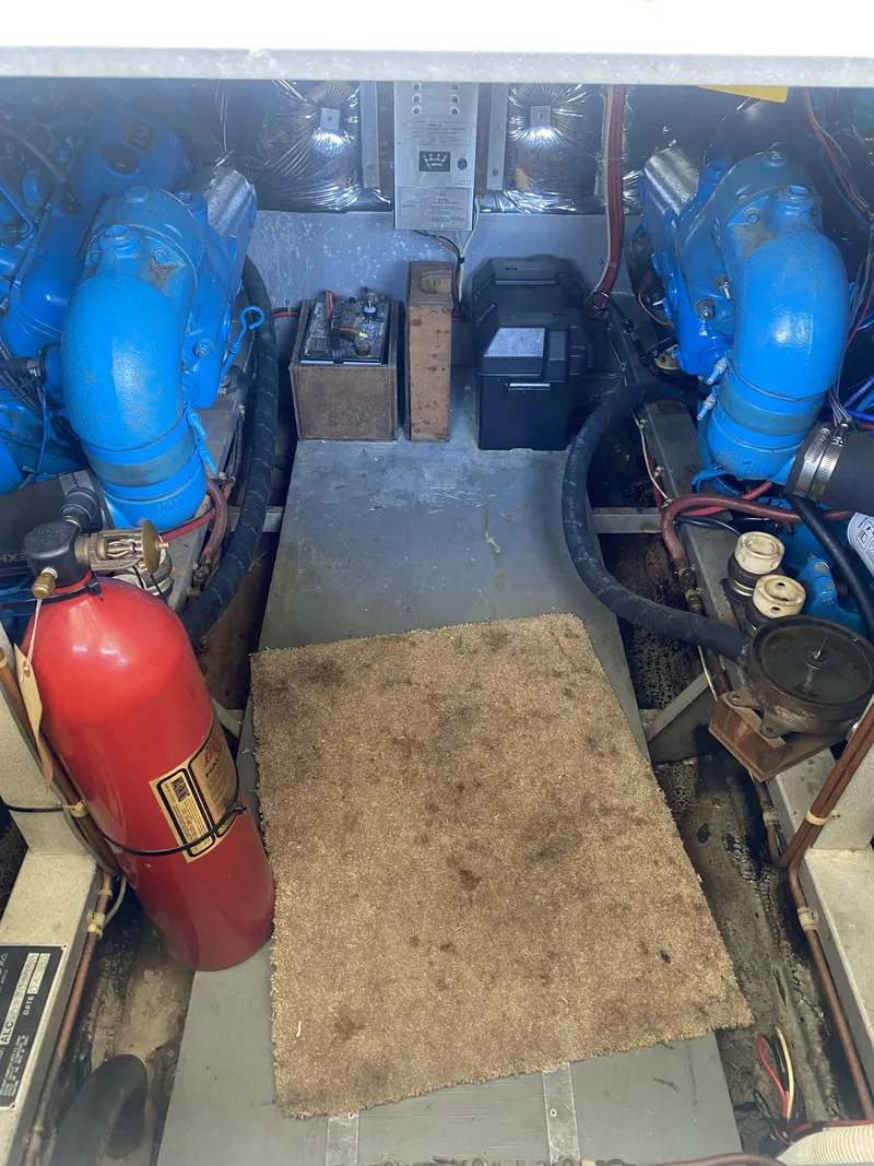 Slide: The Image of Engine room of 1989 Marinette 41 Marquis Convertible with blue engines and fire extinguisher. - 26