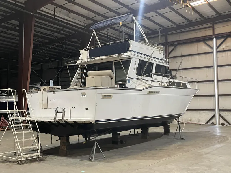 Slide: The Image of 1989 Marinette 41 Marquis Convertible boat in indoor storage facility. - 3