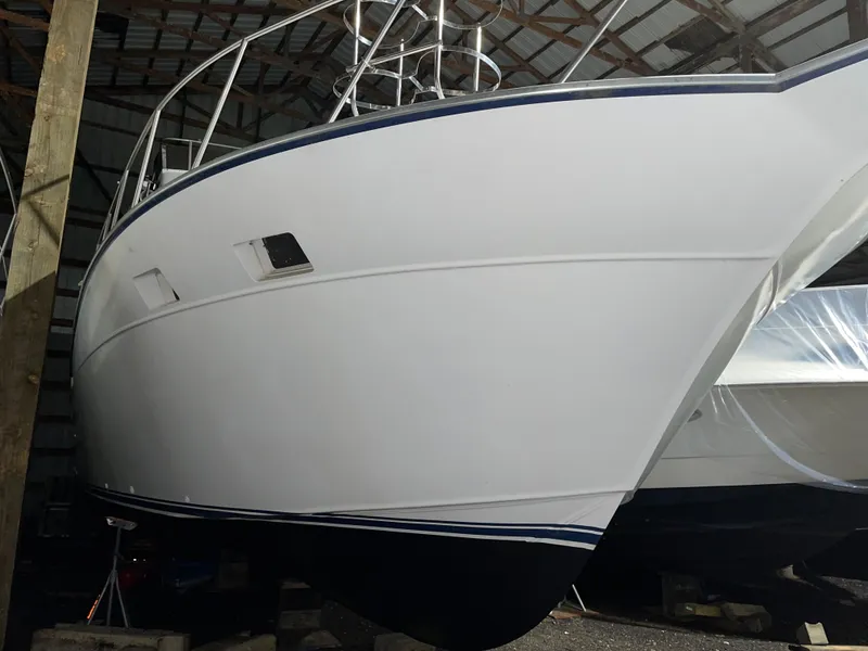 Slide: The Image of 1989 Marinette 41 Marquis Convertible boat in storage, side view. - 4